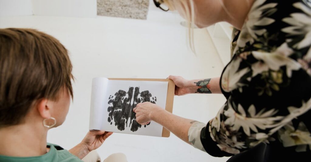 Therapist discussing Rorschach inkblot test with a client in a therapy session.
